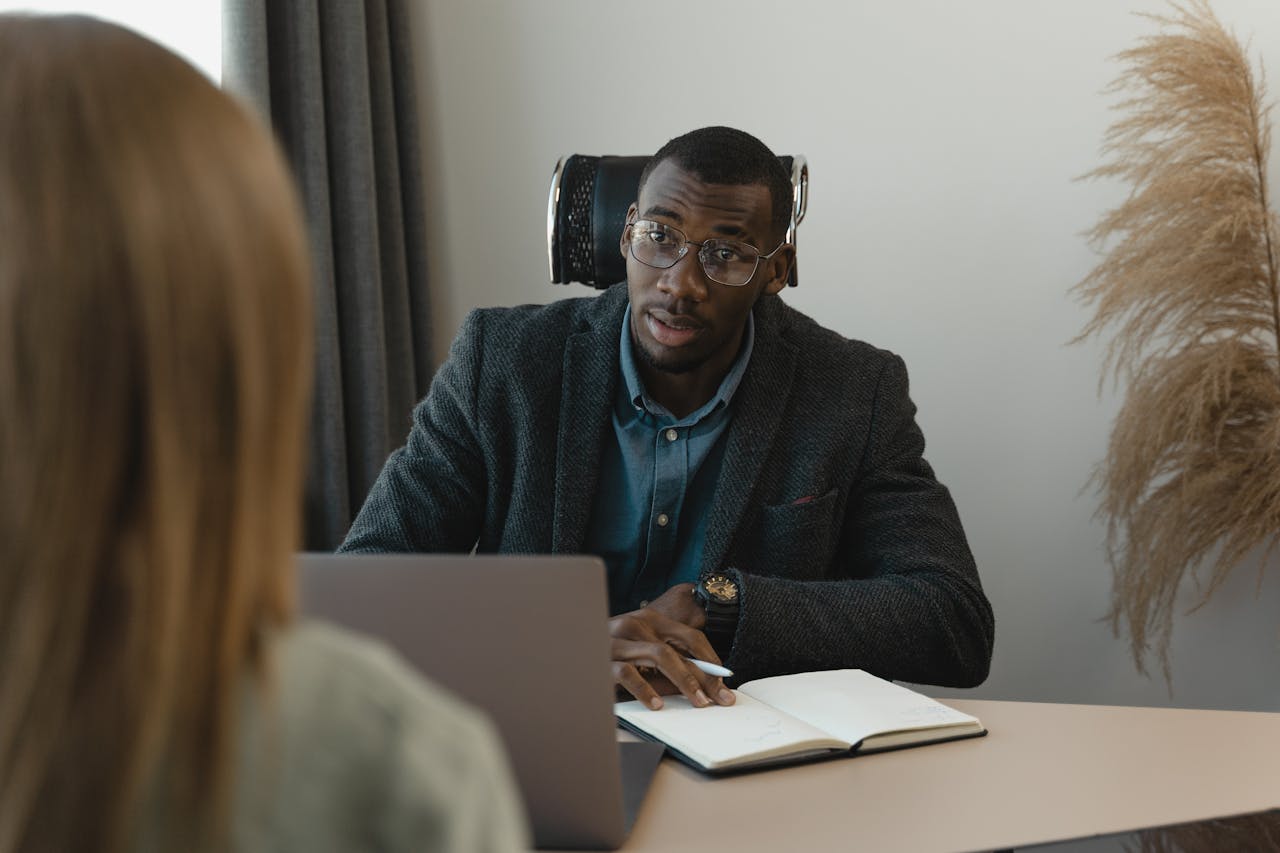 Businessman conducting a formal interview in a modern office environment.